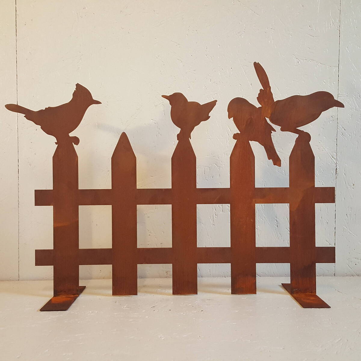 Oiseaux sur barrière en fer rouillé